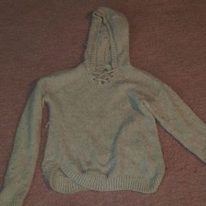 Knitted sweater with pulled out threads